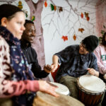 Several people playing drums